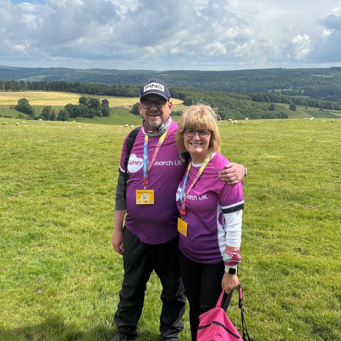 An image of Richard and Jenny during the Peak Ultra Challenge, stood in a field.