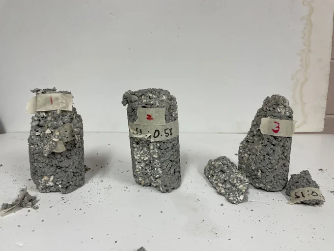 Three concrete cylinder samples after being crushed during a test of their compressive strength