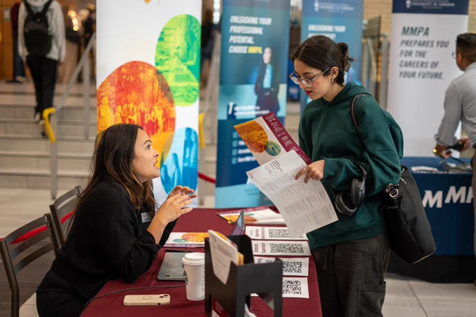 McMaster representative talking to student. 
