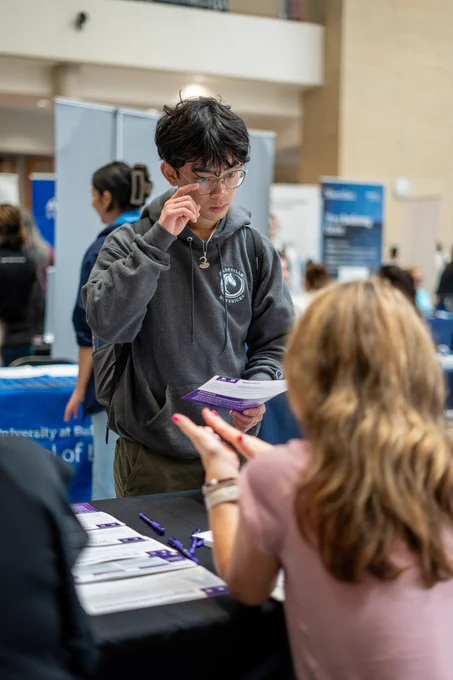 Student talking to school representative. 