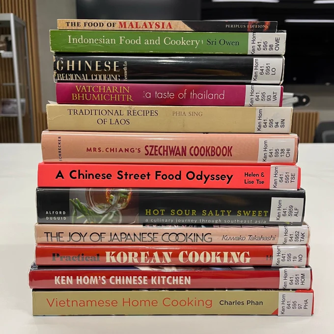 A stack of cookbooks with recipes from around East and South East Asia