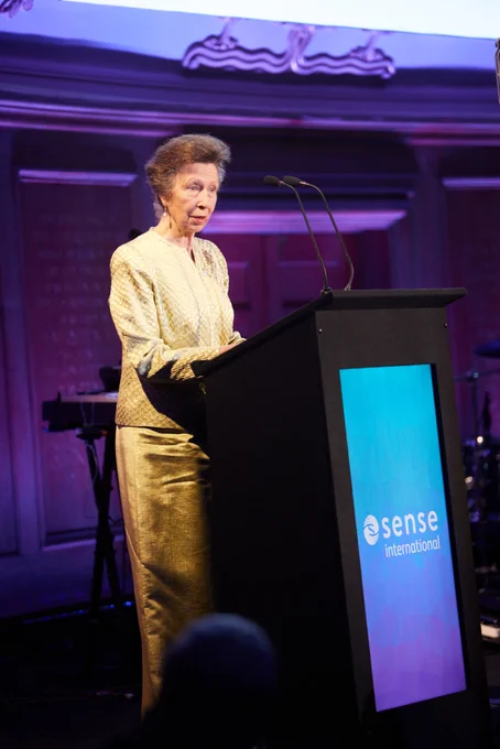 HRH Princess Anne delivering a speech at a Sense International event podium.