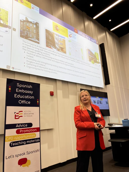 A speaker in front of a presentation