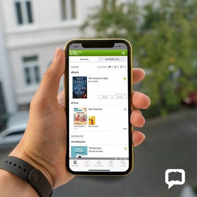 Hand holding a smart phone displaying borrowbox content.