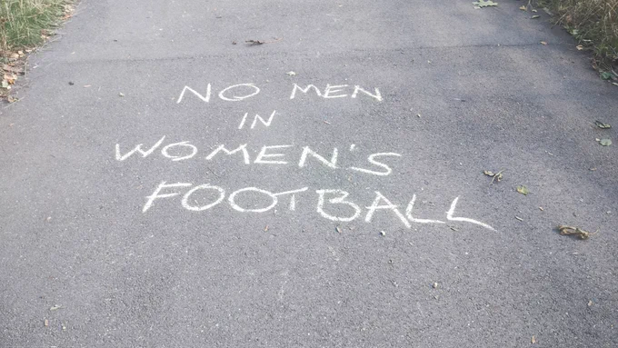 Street art that says no men in women's football.