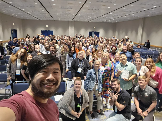 A selfie of me with a lot of people in the background.