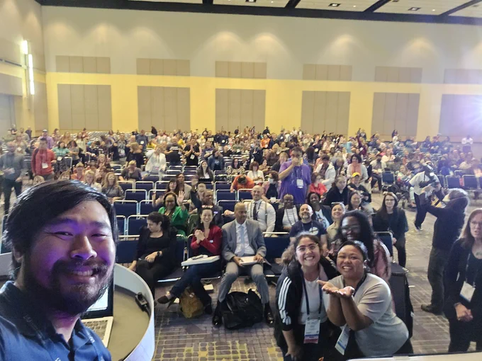 A selfie of me with a lot of people in the background.
