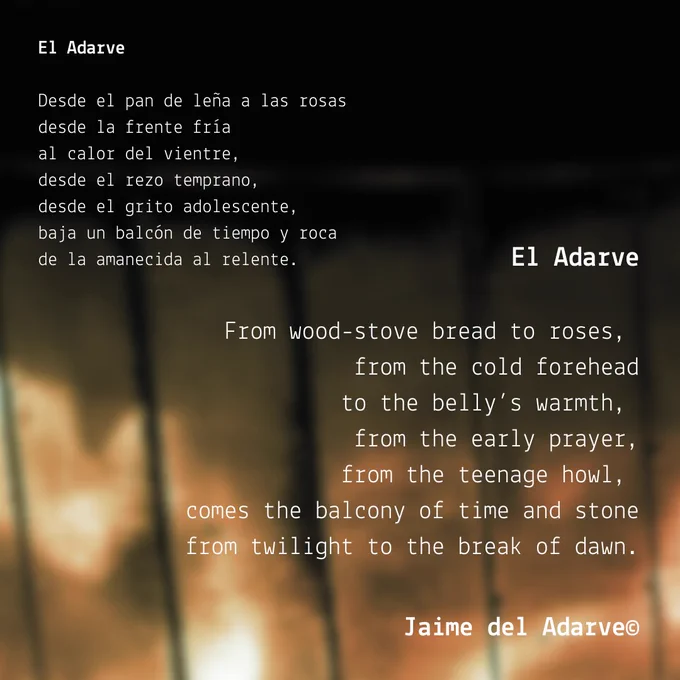 The background image is a close-up of a wood-burner stove, with a slightly green tint. It has an extract from the bilingual version of the poem 'El Adarve' by Jaime del Adarve. It reads:

El Adarve [spanish]
Desde el pan de leña a las rosas
desde la frente fría
al calor del vientre,
desde el rezo temprano,
desde el grito adolescente,
baja un balcón de tiempo y roca
de la amanecida al relente.

El Adarve [english]
From wood-stove bread to roses, 
from the cold forehead
to the belly’s warmth, 
from the early prayer,
from the teenage howl, 
comes the balcony of time and stone
from twilight to the break of dawn.
