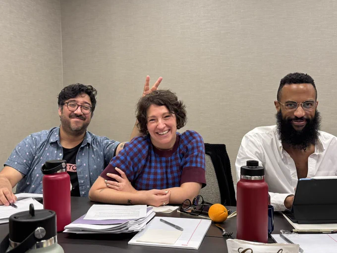Photograph of three smiling scholars at the 2024 Post45 Symposium at Emory University. One is giving another “bunny ears.”
