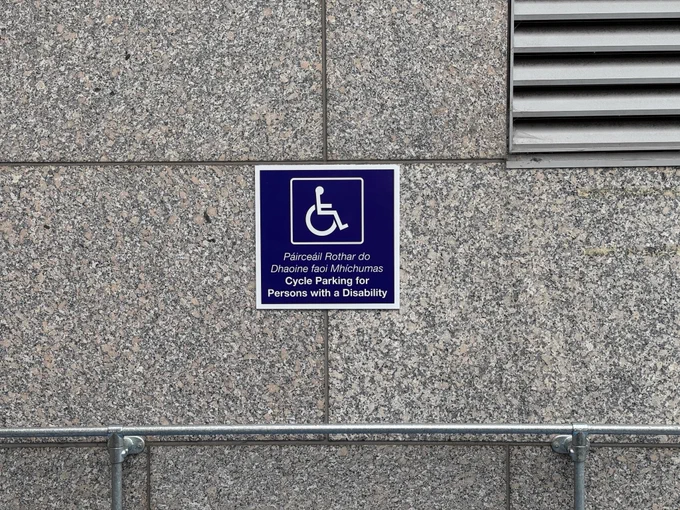 Signage plate saying "cycle parking for persons with a disability" 
