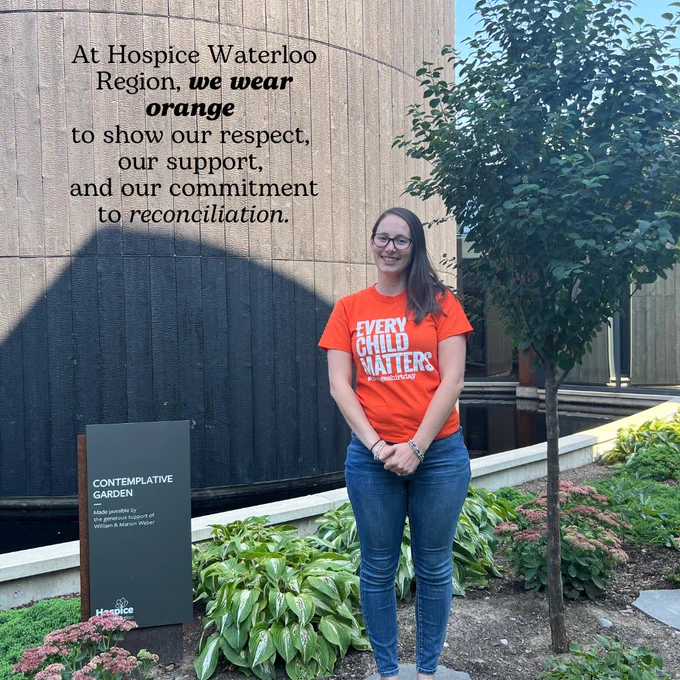 Photo of a woman standing in a garden wearing an "Every Child Matters" t-shirt. Text overlay says "At Hospice Waterloo Region, we wear orange to show our respect, our support, and our commitment to reconciliation."