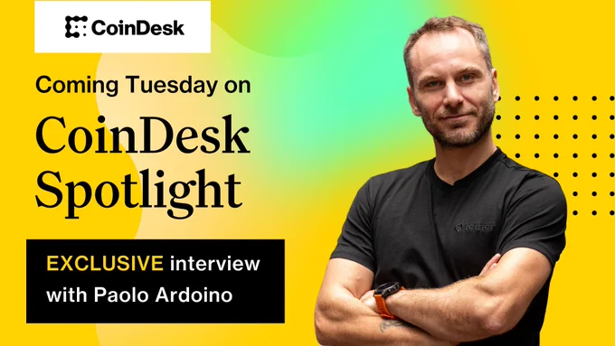 Promotional image for CoinDesk Spotlight featuring an exclusive interview with Paolo Ardoino. Paolo is smiling, wearing a t-shirt, with crossed arms against a vibrant yellow and green background.