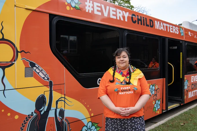Artist Judy Ross Mack with the Every Child Matters bus featuring her artwork.
