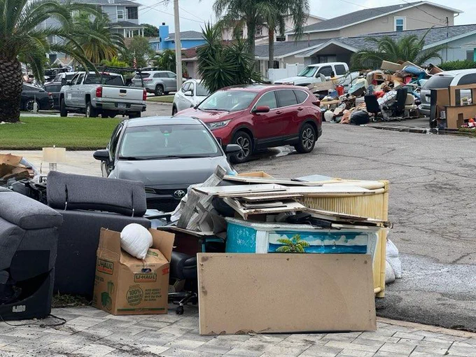 Damaged belongings line an affected community in Florida.