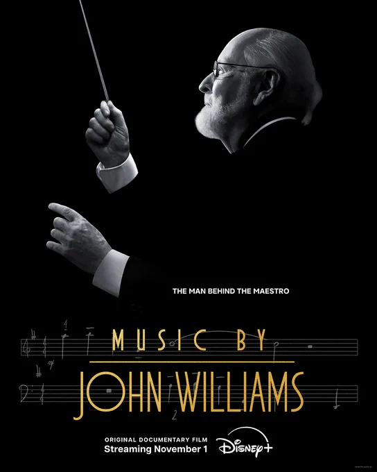 A poster featuring a black and white image of legendary composser John Williams conducting. With the following words: "The Man Behind The Maestro."

The title says : "Music by John Williams"

Original documentary film. Streamig November 1st on Disney 