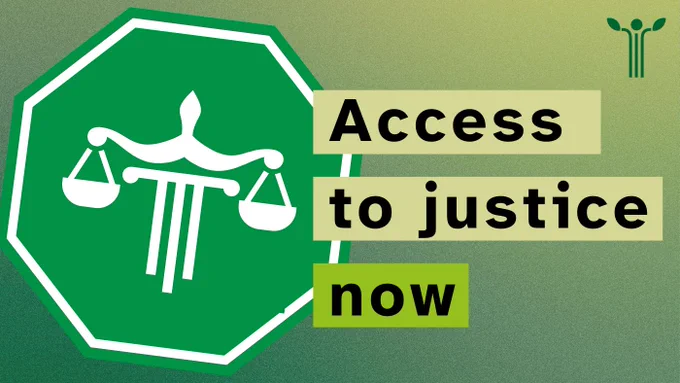 A green traffic sign with the scales of justice, and the text 'Access to justice now'. 