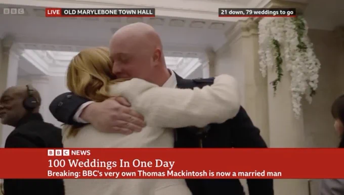 Breaking: BBC's very own Thomas Mackintosh is now a married man as he hugs someone at the wedding.