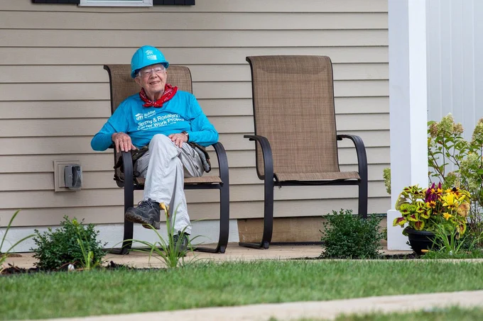 Former United States President, Jimmy Carter, sits in front of a Habitat for Humanity home at the 2018 Carter Work Project in Indiana. 