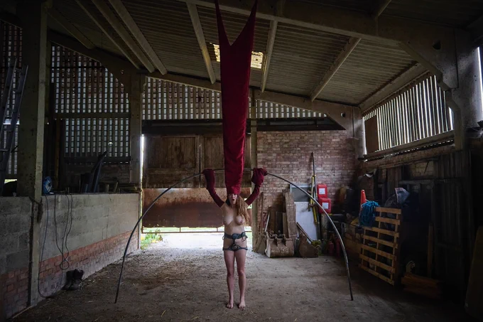 
Documentation of a performance taking place in different locations within a British rural landscape. The performer is a white woman in her 40s, and she’s performing wearing just a slide harness throughout.