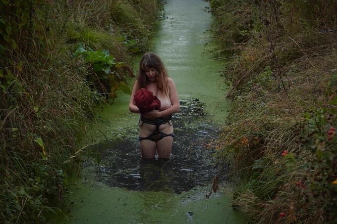 
Documentation of a performance taking place in different locations within a British rural landscape. The performer is a white woman in her 40s, and she’s performing wearing just a slide harness throughout.