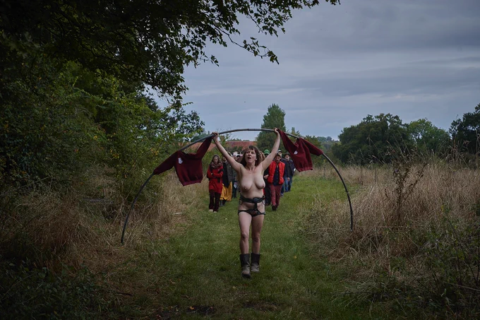 
Documentation of a performance taking place in different locations within a British rural landscape. The performer is a white woman in her 40s, and she’s performing wearing just a slide harness throughout.