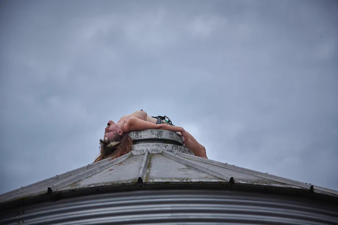 
Documentation of a performance taking place in different locations within a British rural landscape. The performer is a white woman in her 40s, and she’s performing wearing just a slide harness throughout.