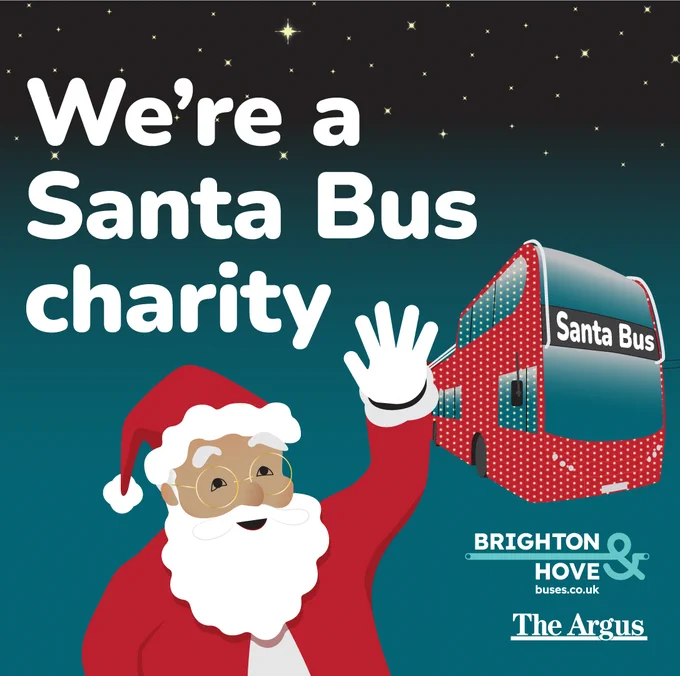 A cheerful cartoon Santa Claus is waving next to the words 'We're a Santa Bus charity'