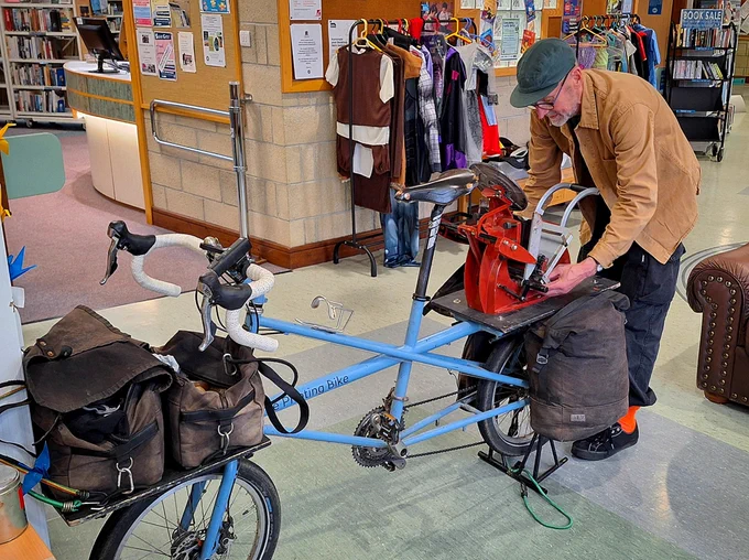 Nick Hand setting up his bike mounted printing press