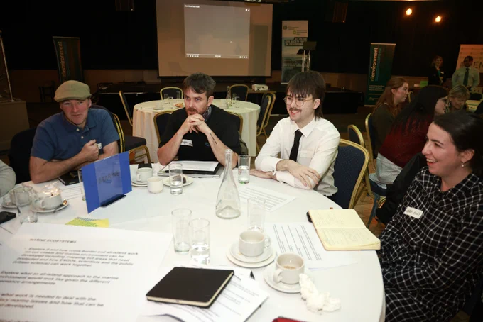 Photograph of four delegates at a round table during one of the workshops.