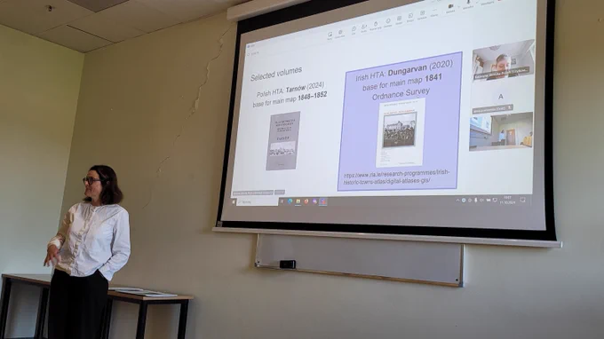 Sarah Gearty giving her presentation in front of a screen
