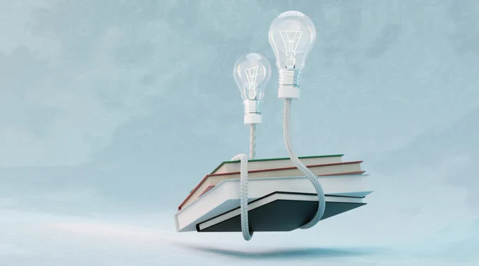 Two lightbulbs connected with a plated, white, cable. The cable is wrapped around four books that lies on top of each other. The lightbulbs holds the books above the surface, like they are flying. Galina Nelyubova
For Unsplash 