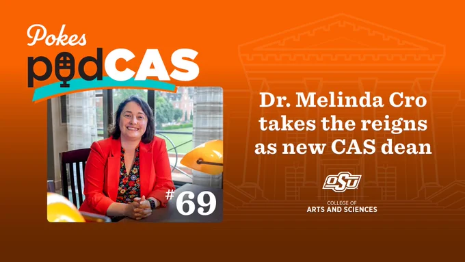 Image of woman with shoulder-length brown hair, wearing an orange blazer and sitting at a desk in front of a large window with brick buildings in the background. Text says Pokes PodCAS: Dr. Melinda Cro takes the reigns as new CAS dean. OSU College of Arts and Sciences.