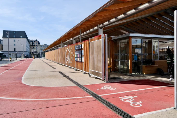 An elegant new 1,200-bike parking facility at Gare du Nord Station in Paris includes integrated signage, a guarded entrance, two-tiered racks, and a repair station.
