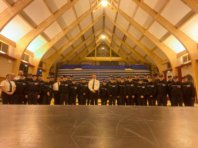 A photo of the dover cadets with ACC Brookes in a hall.