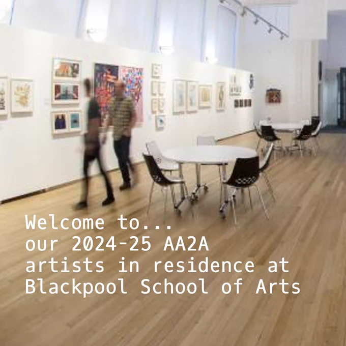Colour photo of blurred figures in modern gallery space with tables, chairs and wooden floor
