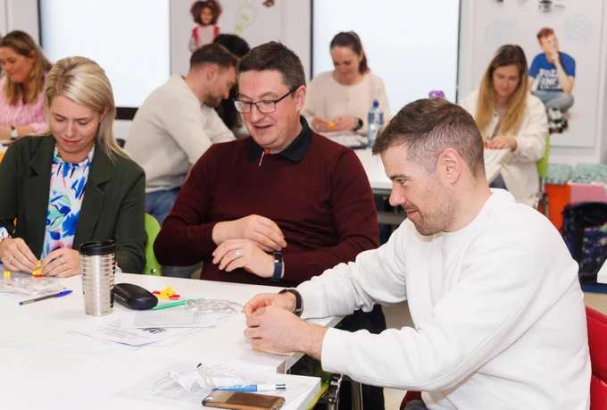 Teachers engaged in hands-on activities during the launch event