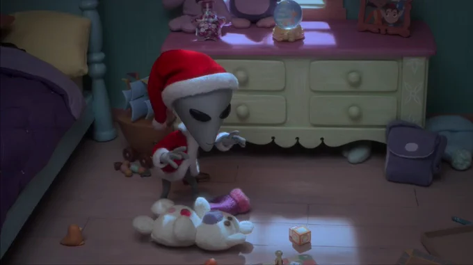 An alien in a Santa suit sneaks around a child’s bedroom.