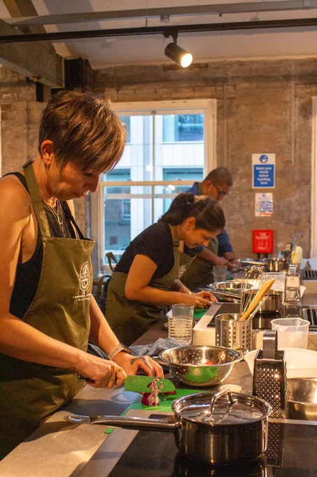 People preparing food at a cooking workshop 