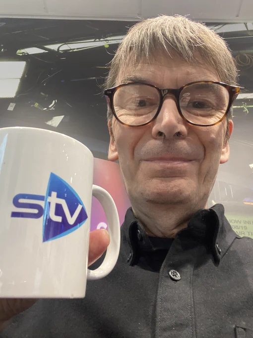 In the Scottish Television studio with a mug of tea. No, really.