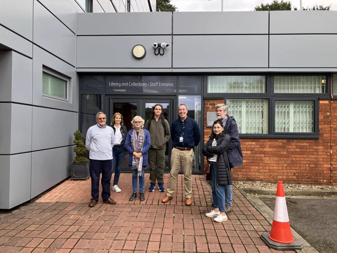 A group of people outside a museum.