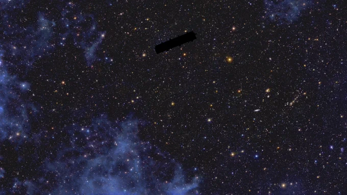  An ethereal patch of a dark starry sky with millions of tiny dots of light scattered across the image evenly. Mystical swathes of light blue clouds are seeping in from the edges of the picture. Most light sources appear as little points scattered across the dark background, with just a few of them standing out brighter than the rest. A bright, golden yellow star in the upper right quarter of the image draws particular attention. The wispy clouds framing the outskirts of the picture seem to be moving into the image centre and dampen the light of the stars behind. The largest patch of these is visible in the lower left of the picture. In the centre of the upper half of the picture there is a black tilted rectangle devoid of any colour which seems as if a part of the image had been wiped with an eraser.
