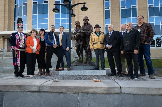 Group photo with the bronze statue outside the Confederation Building.