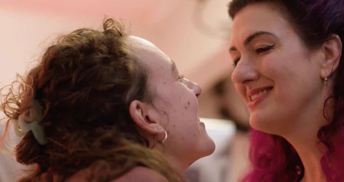 Lilith and Sadie smile at each other