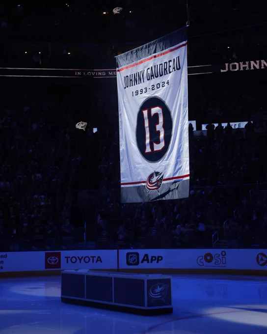 A photo of a banner raised by the Columbus Blue Jackets in memory of Johnny Gaudreau.