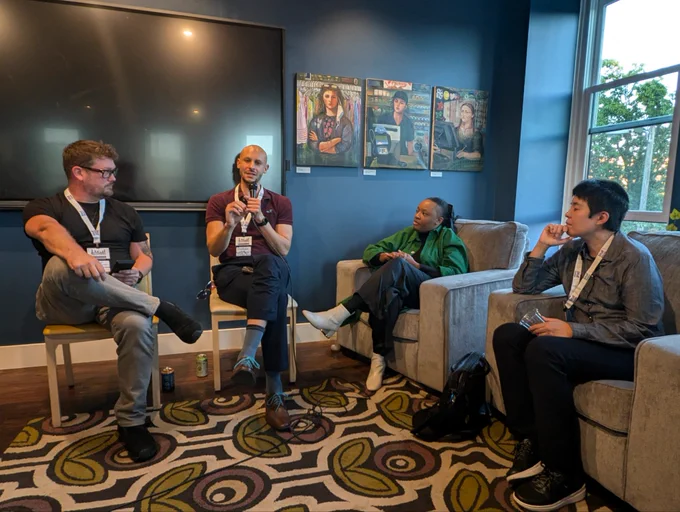 Leah Johnson, Stephen Lane, Ann Matsuuchi, and Jason Aukerman sitting in a row on a panel