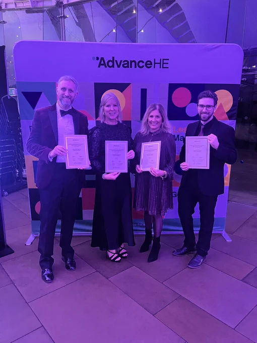 4 award winners holding their certificates