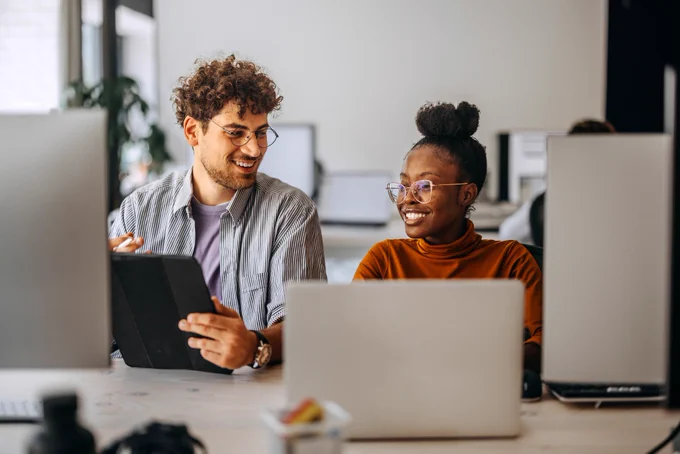 Two entrepreneurs with laptops