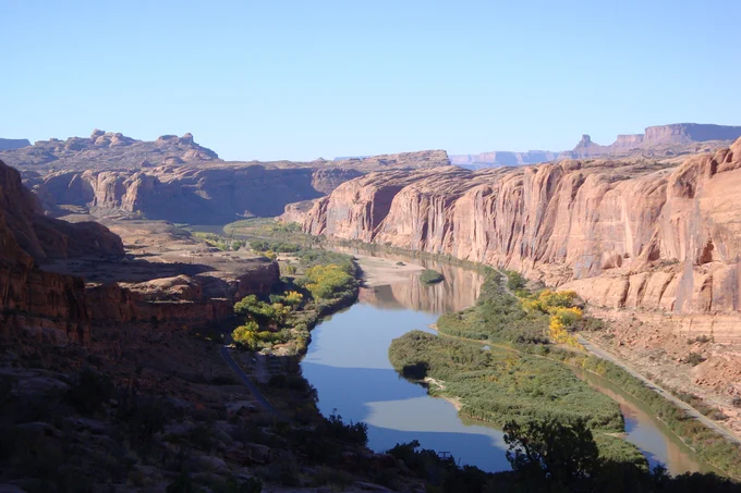 The Colorado River flowing between red rock canyons