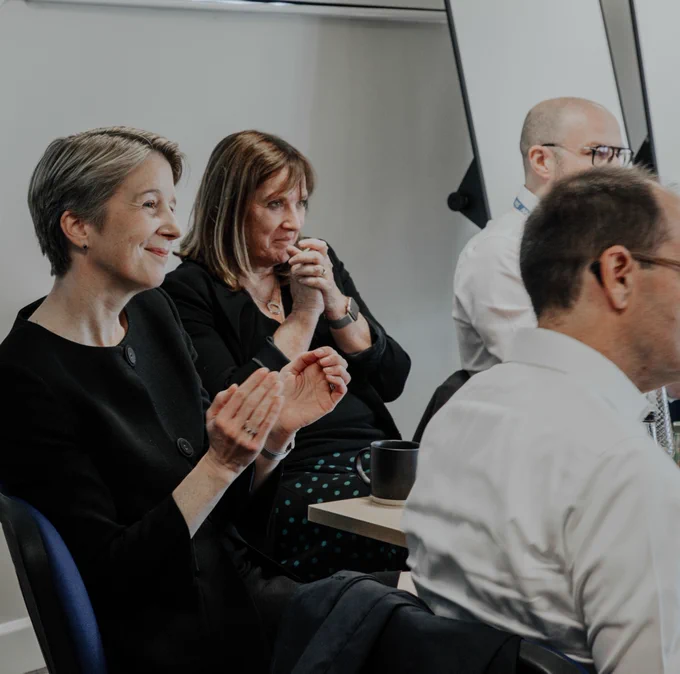NHS England CEO Amanda smiling and clapping