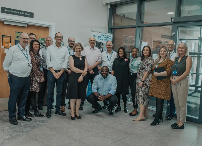 NHS England, LSCft and ICB colleagues stood next to each other in the harbour reception smiling
